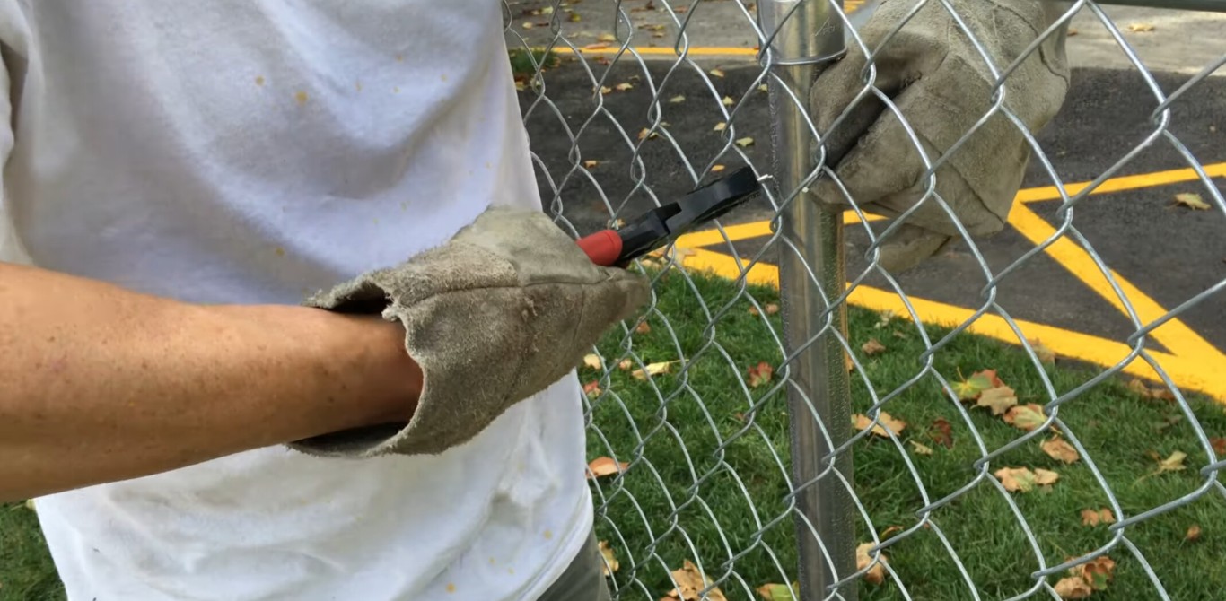 Professional fence contractor installing chain-link fence